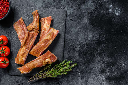 Smoked pork ribs. Barbeque spicy spareribs. BBQ food. Black background. Top view. Copy space.の写真素材