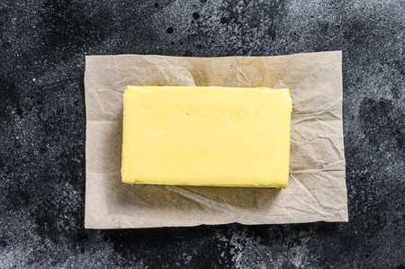 Butter on craft paper, dairy farm products. Black background.Top view.の写真素材
