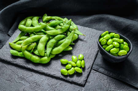Raw Green edamame soybeans. Black background. Top view.の写真素材