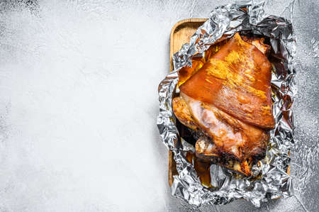 Roast pork knuckle with pepper and spices. Gray background. Top view. Copy space.の写真素材