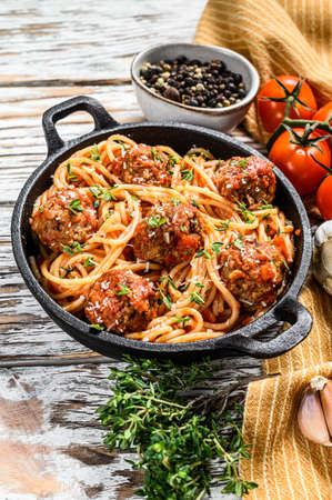 Spaghetti pasta with meatballs and tomato sauce. White wooden background. Top view.の写真素材