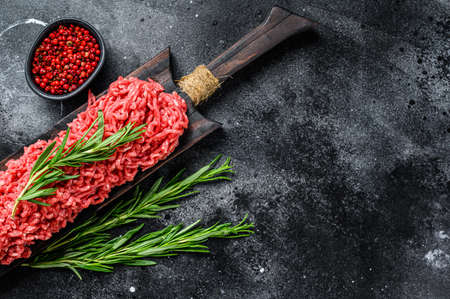 Raw Mince Ground meat with pepper. Black background. Top view. Copy space.の写真素材