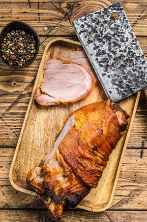 Sliced baked pork leg on a cutting board. wooden background. Top view.の写真素材