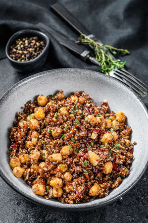 Boiled quinoa with chickpeas. Healthy food, diet. Black background. Top view.の写真素材