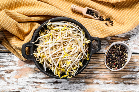 Bowl with Mungbean Sprouts on wooden background. White background. Top view.の写真素材