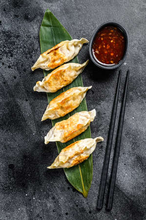 Fried dumplings. Chinese food cooking. Black background. Top view.の写真素材