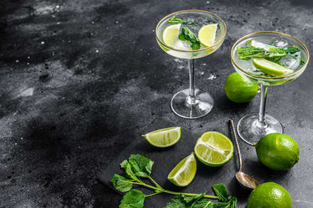 Mojito cocktail, Refreshing mint with rum and lime, cold drink or beverage. Black background. Top view. Copy space.の写真素材