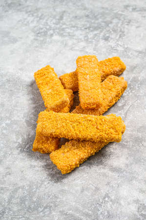 Frozen fish sticks. Organic fish food. Gray background. Top view.の写真素材