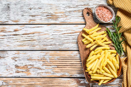 Frozen potatoes in a bowl, French fries, canned food. White background. Top view. Copy space.