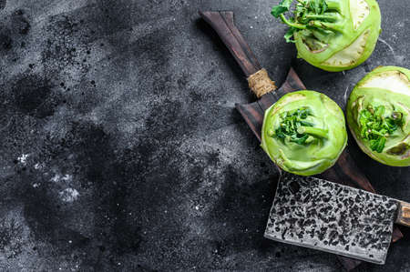 Heads of fresh ripe white cabbage kohlrabi. Black background. Top view. Copy space.の写真素材