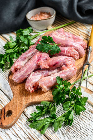 Raw Chicken neck meat, offals. White Wooden background. Top view.の写真素材