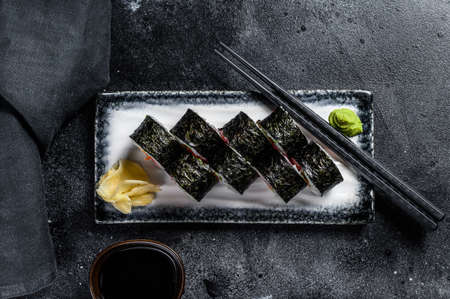 Sushi rolls hosomaki with salmon, avocado and tuna. Black background. Top view.の写真素材