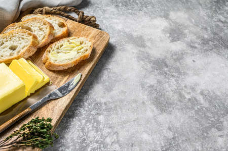 Farm butter and fresh baguette with butter. Gray background.Top view. Copy space.の写真素材