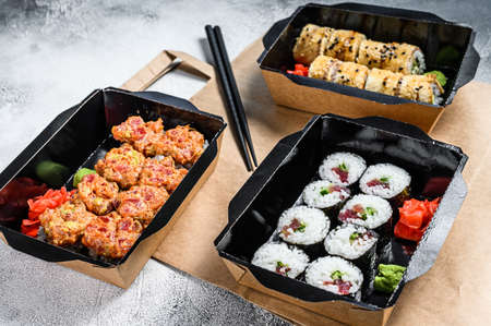 The sushi rolls in the delivery package, ordered in sushi take-out restaurant. Gray background. Top view.の写真素材