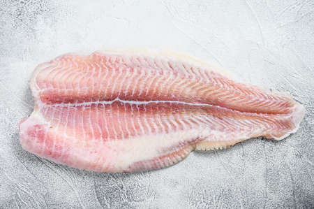 Frozen pangasius fish fillet. Gray background. Top view.の写真素材