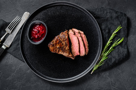 Sliced grilled filet Mignon steak. Beef tenderloin. Black background. Top view.の写真素材