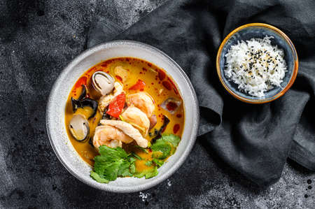 Tom yam kong or Tom yum, spicy clear soup. Tom Yam. Black background. Top view.の写真素材