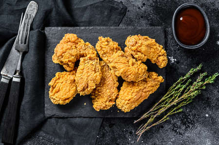Crispy kentucky fried chicken french fries and tomato. Black background. Top view.の写真素材