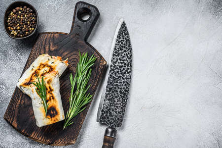 Burrito with grilled chicken and vegetables, fajitas, shawarma. White Wooden background. Top view....