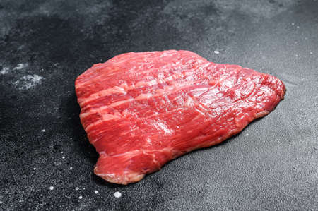 Raw flat iron steak. Marble beef black Angus. Black background. Top view.の写真素材