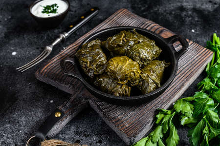 Dolma stuffed grape leaves with rice and meat. Black background. Top view.の写真素材