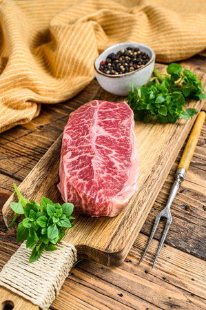 Raw marble beef meat steak. wooden background. Top view.の写真素材