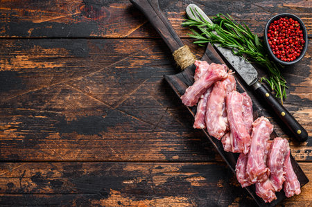 Chicken neck meat on a cutting board. Wooden background. Top view. Copy space.の写真素材