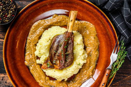Stew Lamb Shanks with mash potato on a plate. Black background. Top view.の写真素材