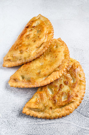 Latin American fried empanadas savory pastries with meat. White background. Top view.