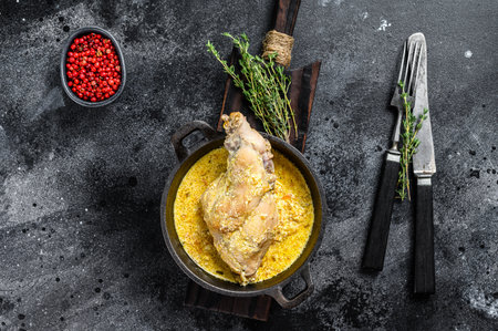 Roasted Rabbit Haunches in Pan with Stewed Vegetables. Black background. Top view.の写真素材