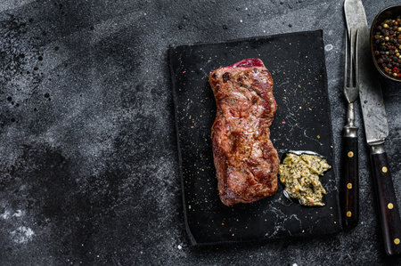 Grilled machete or skirt beef steak. Black background. Top view. Copy space.の写真素材