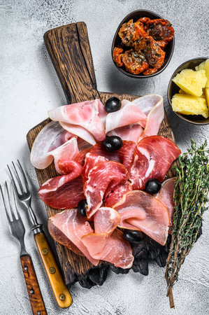 Cured meat platter of traditional Spanish tapas. White background. Top view.の写真素材