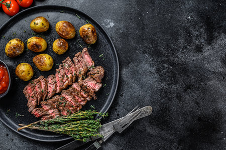 Grilled marble meat beef Steak with fried potato. Black background. Top view. Copy space.の写真素材