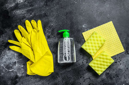 Kitchen yellow cleaning concept, housecleaning, hygiene, spring, chores, cleaning supplies. Black background. Top viewの写真素材
