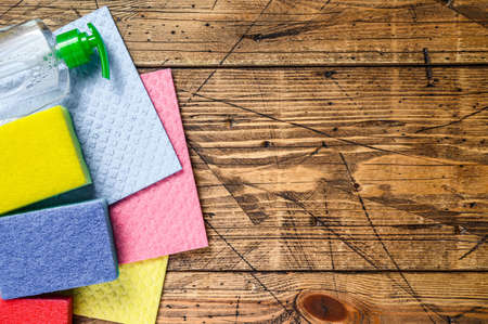 Washing and cleaning stuff, domestic supplies for spring cleaning service. wooden background. Top view. Copy spaceの写真素材