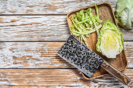 Fresh sliced Green pointed cabbage. Wooden background. Top view. Copy spaceの写真素材