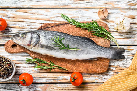 Sea bass fish with herbs, raw seabass. White background. Top viewの写真素材