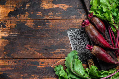 Purple beet on a cutting board. Dark wooden background. Top view. Copy spaceの写真素材