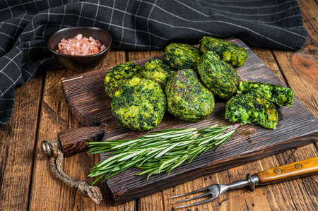 Roasted vegetarian broccoli and pea vegetable patty or cutlet, falafel. wooden background. Top viewの写真素材