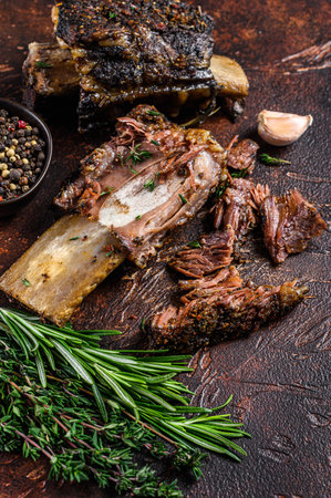BBQ Grilled short beef ribs on a kitchen table. Dark background. Top viewの写真素材