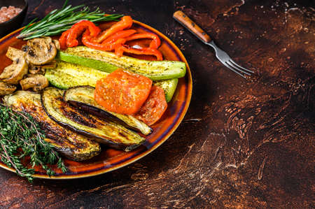 Grilled mix vegetables in a rustic plate. Dark background. Top view. Copy spaceの写真素材