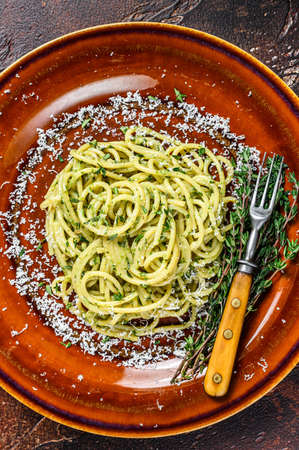 Spinach Spaghetti Pasta with pesto sauce and parmesan. Dark background. Top viewの写真素材