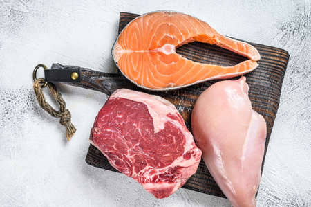 Set of raw meat steaks salmon, beef and chicken. White background. Top viewの写真素材