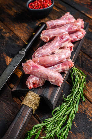 Chicken neck meat on a cutting board. Wooden background. Top viewの写真素材