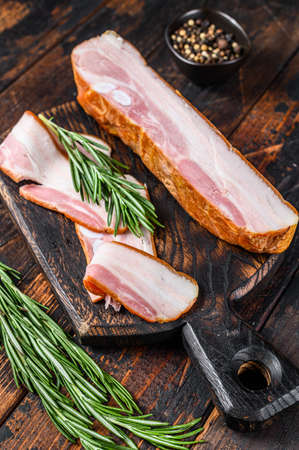 Raw pork belly with skin. Dark wooden background. Top viewの写真素材