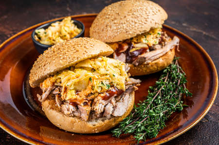 Pulled Pork meat Hamburger with coleslaw salad. Dark background. Top view