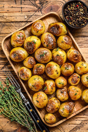 Roasted potato with thyme and salt. wooden background. Top viewの写真素材