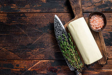 Butter Spread block on a wooden board. Dark wooden background. Top view. Copy spaceの写真素材