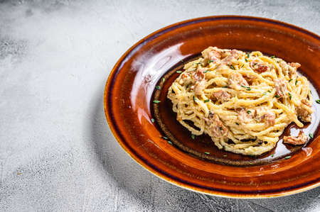 Italian Spaghetti Carbonara pasta with bacon, hard parmesan cheese and cream sauce. White background. top view. Copy spaceの写真素材