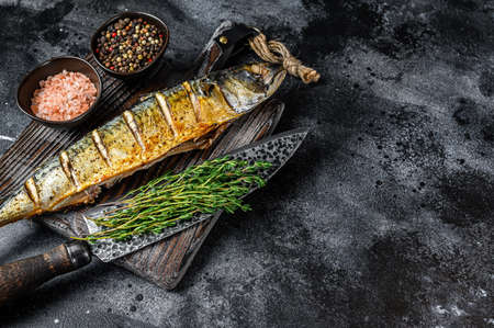 BBQ Grilled mackerel fish with herbs. Black background. Top view. Copy spaceの写真素材